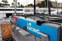 Sailboat with "I'm Racing" text, docked at marina, GC 32 model, 2012.