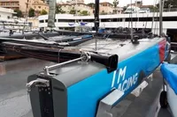 Sleek GC 32 racing yacht docked, featuring vibrant blue and gray design, 2012 model.