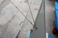 Sailboat rigging and netting on a GC 32 model, 2012, docked on concrete.