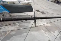 Sailboat rigging and netting on a GC 32 model, 2012, docked on concrete.