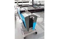 Blue and black GC 32 catamaran from 2012 on a wheeled stand.