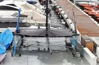 Catamaran docked at marina, surrounded by other boats, GC 32 model, 2012.