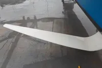 White airplane wing on wet tarmac, GC 32 model, 2012.