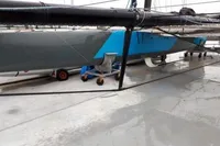 2012 GC 32 sailboat on a trailer, featuring a sleek blue and gray hull design.