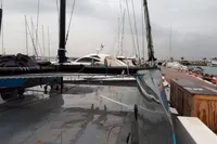 Sleek GC 32 catamaran docked at marina, overcast sky, 2012 model.