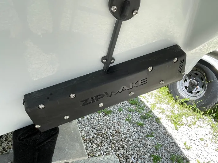 Whisper Gray Yacht Photos Pics Trim tab on 2025 Everglades 315 Center Console boat, featuring Zipwake technology.