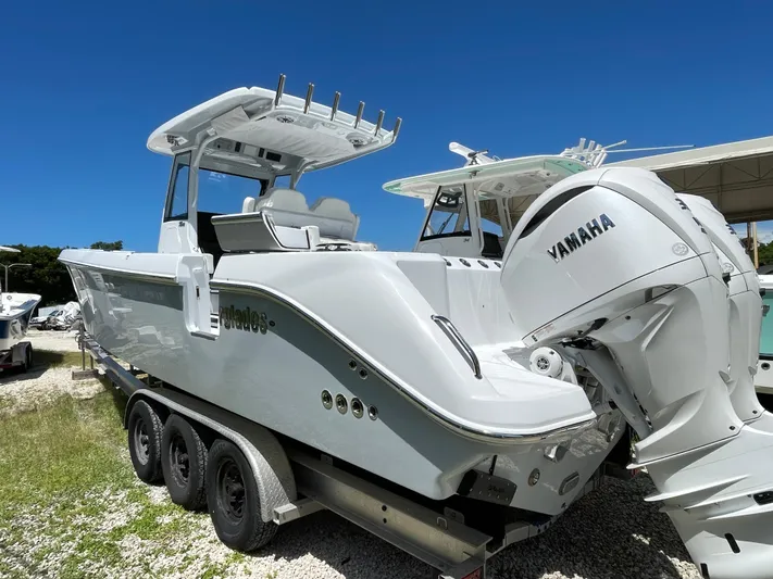 Whisper Gray Yacht Photos Pics 2025 Everglades 315 Center Console boat with Yamaha engine, parked on a trailer.