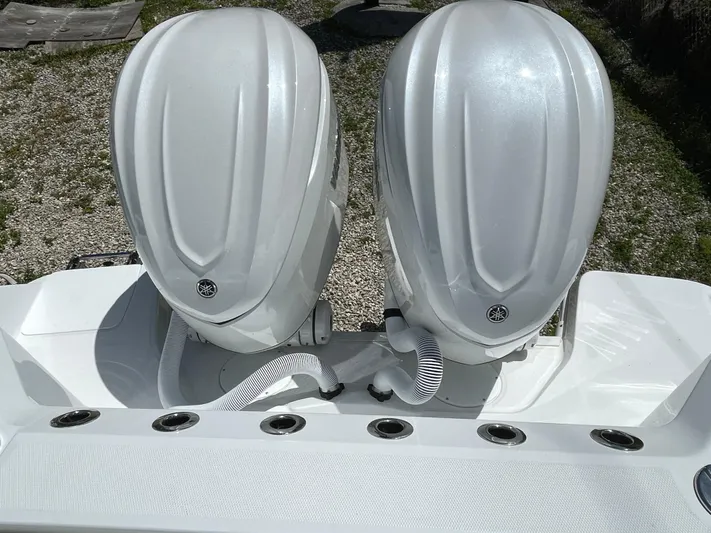 Whisper Gray Yacht Photos Pics 2025 Everglades 315 Center Console boat with dual outboard engines, rear view.