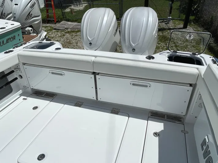Whisper Gray Yacht Photos Pics 2025 Everglades 315 Center Console boat with dual outboard engines, white seating, and storage compartments.