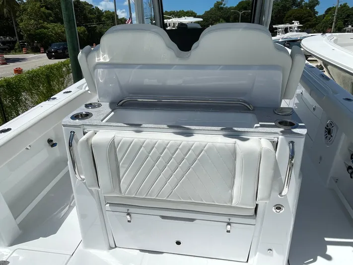 Whisper Gray Yacht Photos Pics 2025 Everglades 315 Center Console boat interior with white seating and storage.