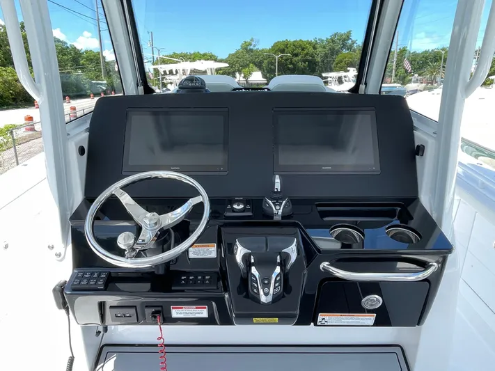 Whisper Gray Yacht Photos Pics 2025 Everglades 315 Center Console boat dashboard with dual screens and steering wheel.
