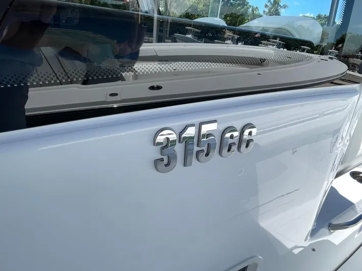 Whisper Gray Yacht Photos Pics 2025 Everglades 315 Center Console boat with "315cc" emblem on the side.