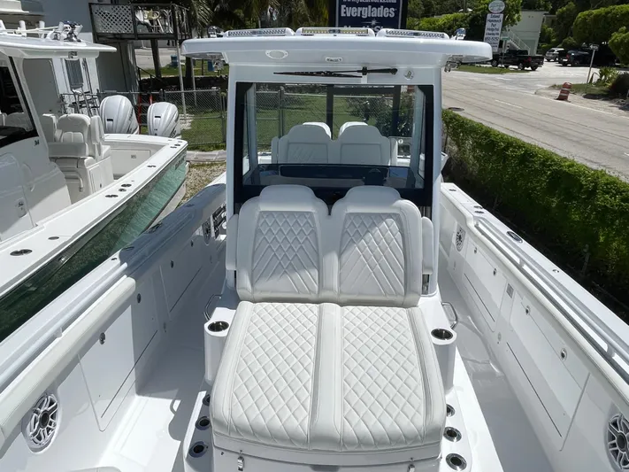 Whisper Gray Yacht Photos Pics 2025 Everglades 315 Center Console boat with luxurious white seating and modern design.