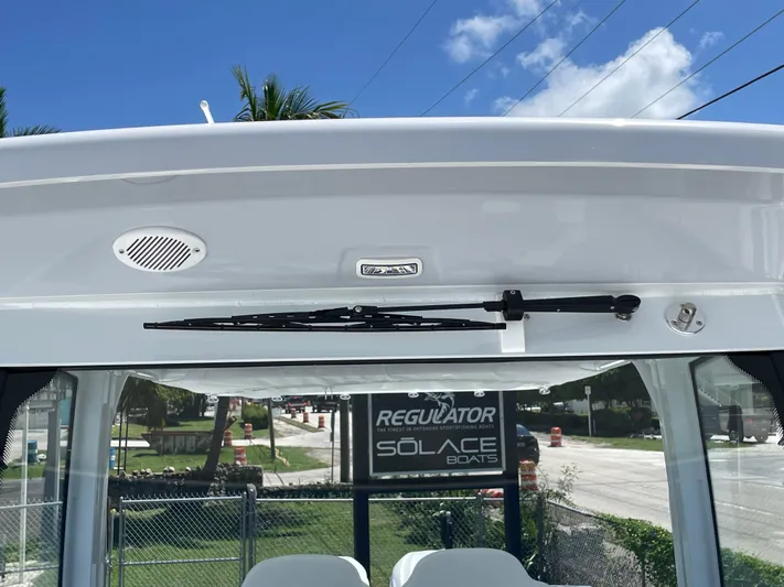Whisper Gray Yacht Photos Pics 2025 Everglades 315 Center Console boat windshield with wiper and speaker, outdoor setting.