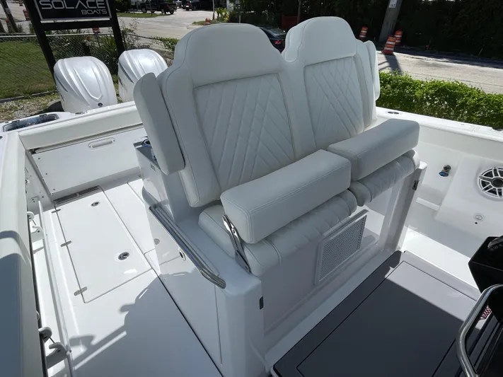 Whisper Gray Yacht Photos Pics 2025 Everglades 315 Center Console boat with white cushioned seating and dual engines.