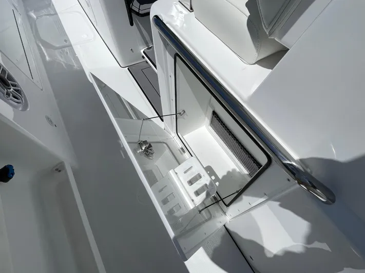 Whisper Gray Yacht Photos Pics 2025 Everglades 315 Center Console boat interior with open storage compartment.