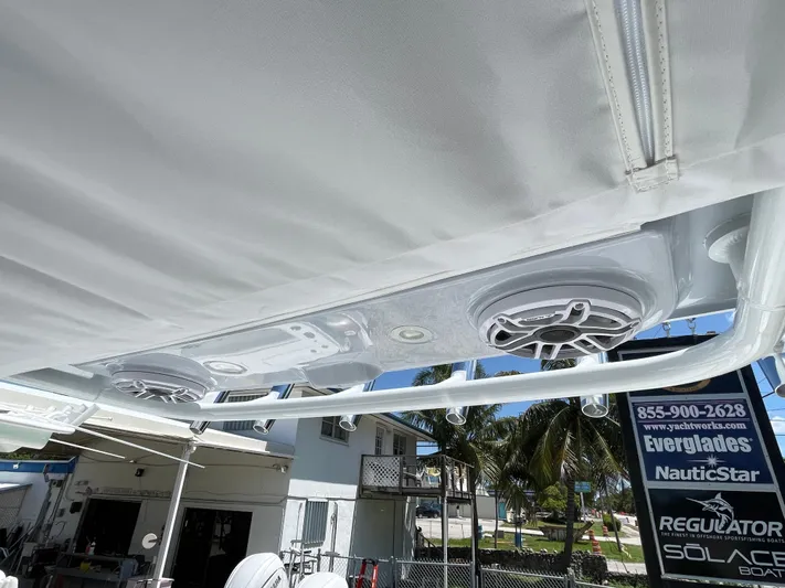Whisper Gray Yacht Photos Pics 2025 Everglades 315 Center Console boat speakers under canopy, outdoor setting.