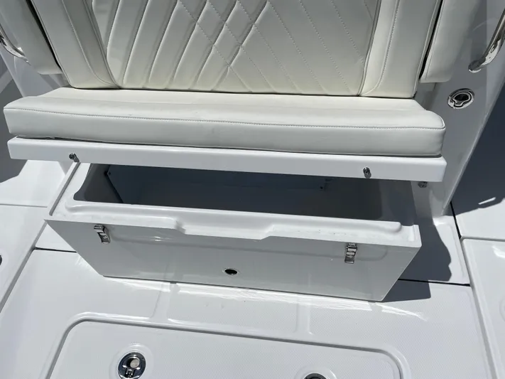Whisper Gray Yacht Photos Pics 2025 Everglades 315 Center Console boat seat with open storage compartment.