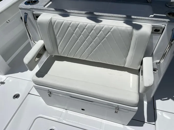 Whisper Gray Yacht Photos Pics 2025 Everglades 315 Center Console boat seat with white cushioned upholstery.