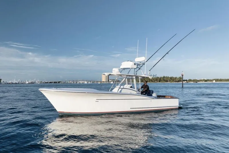 Candy Ride Yacht Photos Pics 2011 Winter Custom Yachts 29 boat on calm water, clear sky background.