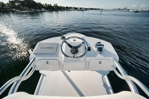 Candy Ride Yacht Photos Pics Steering console of 2011 Winter Custom Yachts 29 on calm water, featuring Garmin equipment.