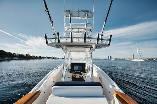Candy Ride Yacht Photos Pics 2011 Winter Custom Yachts 29 on calm water, showcasing helm and tower under clear sky.