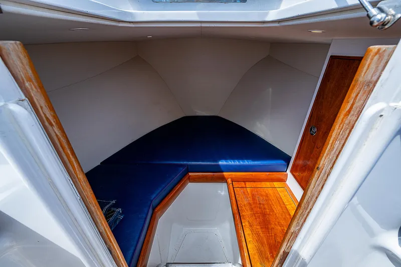 Candy Ride Yacht Photos Pics Interior cabin of 2011 Winter Custom Yachts 29 with blue seating and wooden accents.
