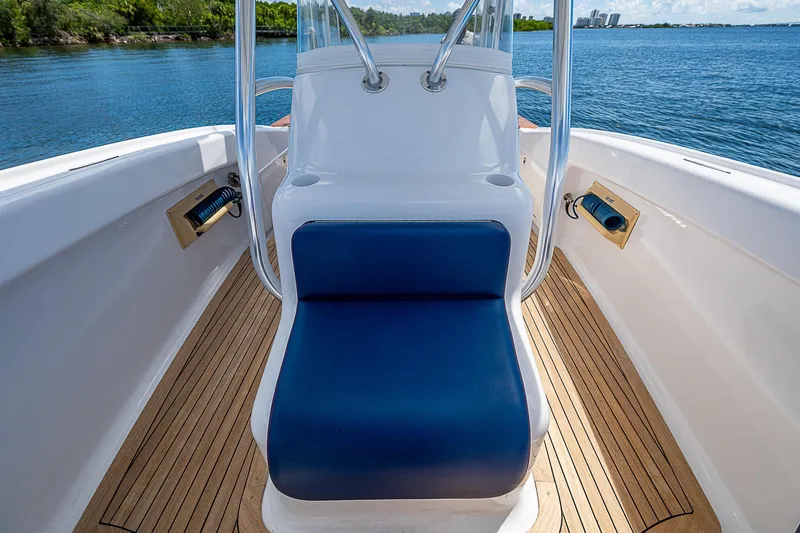 Candy Ride Yacht Photos Pics 2011 Winter Custom Yachts 29 with blue seating, teak deck, and ocean view.