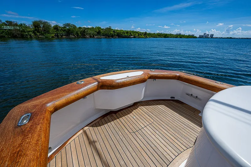 Candy Ride Yacht Photos Pics 2011 Winter Custom Yachts 29, wooden deck, scenic water view, clear blue sky.