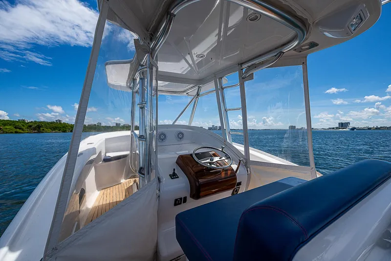 Candy Ride Yacht Photos Pics 2011 Winter Custom Yachts 29 on water, showcasing helm and seating under clear blue sky.