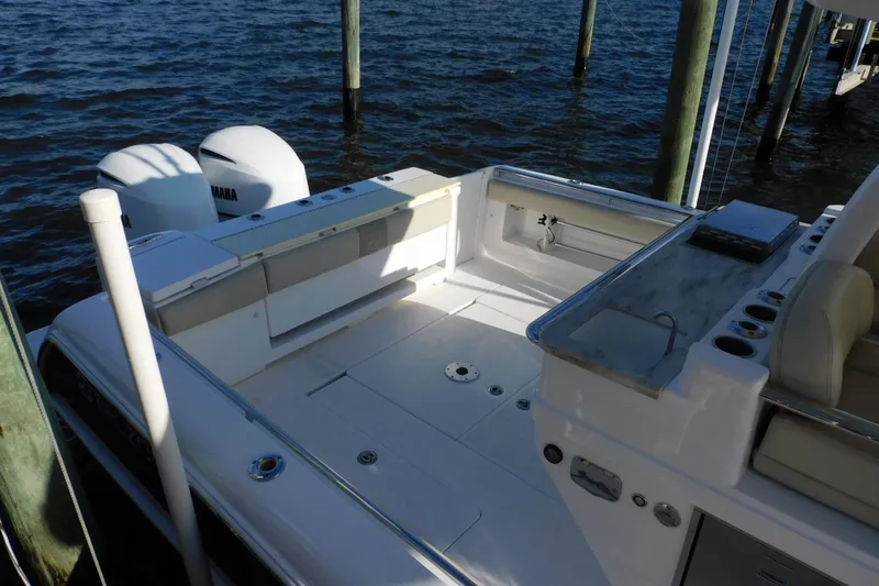 Happily Ever After Yacht Photos Pics 2016 Belzona 327 WA boat deck with Yamaha engines, docked by the water.
