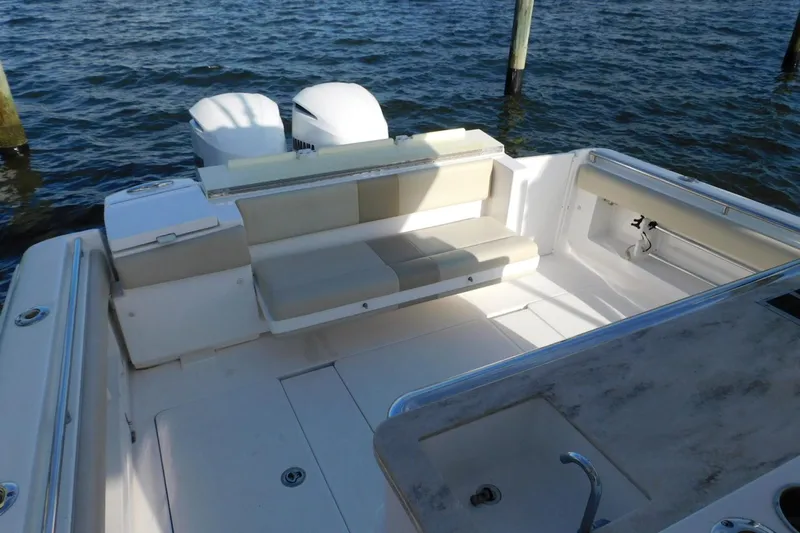 Happily Ever After Yacht Photos Pics 2016 Belzona 327 WA boat interior with seating and twin engines on water.