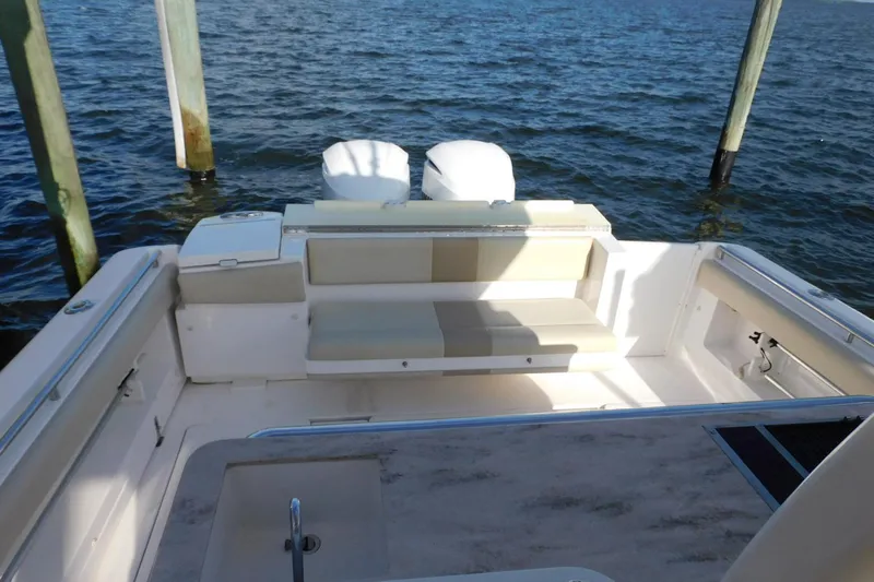 Happily Ever After Yacht Photos Pics 2016 Belzona 327 WA boat interior with seating, docked by the water.