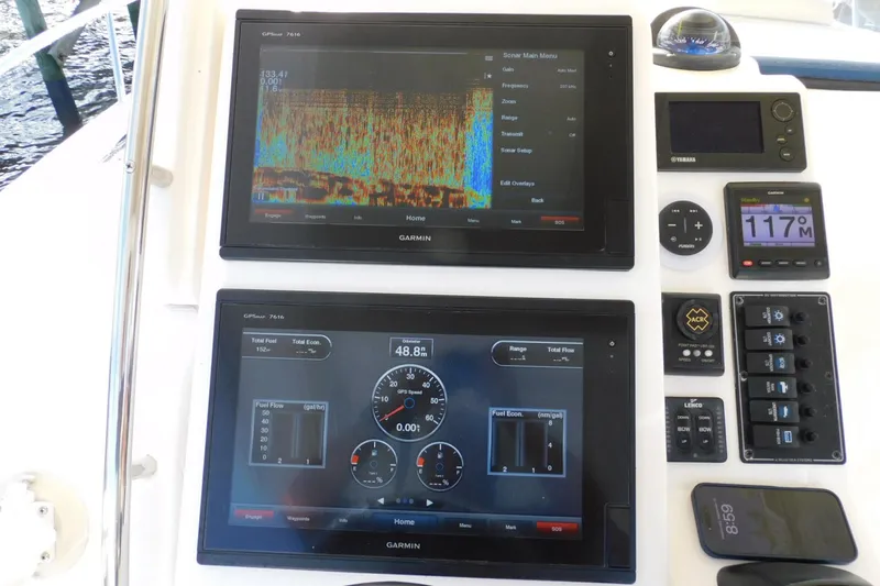 Happily Ever After Yacht Photos Pics Control panel of a 2016 Belzona 327 WA boat with Garmin displays and navigation instruments.