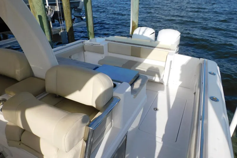 Happily Ever After Yacht Photos Pics 2016 Belzona 327 WA boat interior with beige seating, docked by the water.