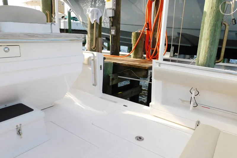 Happily Ever After Yacht Photos Pics Belzona 327 WA 2016 boat interior with white seating and dock view.