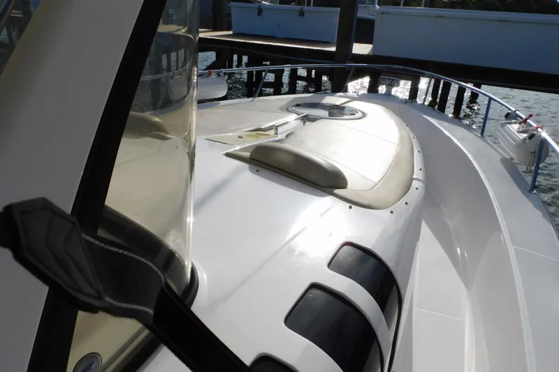 Happily Ever After Yacht Photos Pics 2016 Belzona 327 WA boat deck with seating, docked by the water.