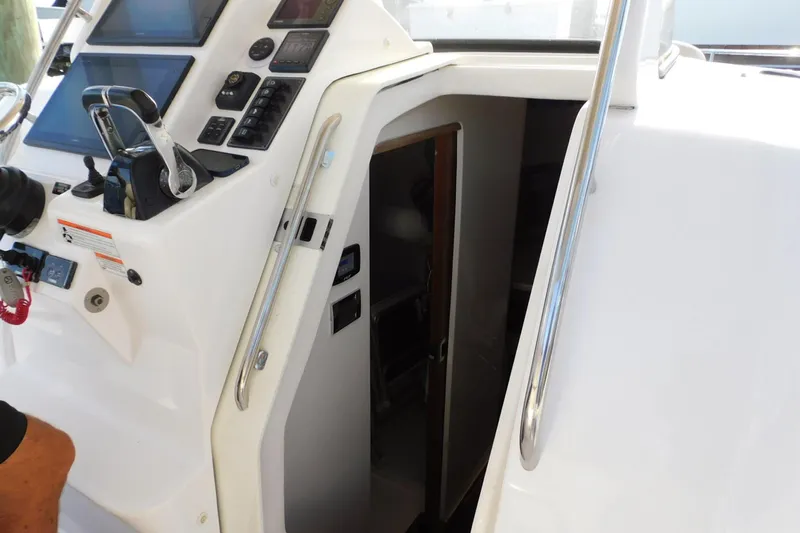 Happily Ever After Yacht Photos Pics 2016 Belzona 327 WA boat cockpit with control panel and cabin entrance.