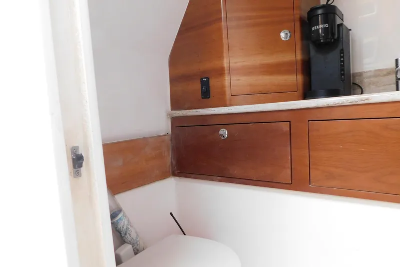 Happily Ever After Yacht Photos Pics Wooden cabinetry and Keurig coffee maker in 2016 Belzona 327 WA boat interior.