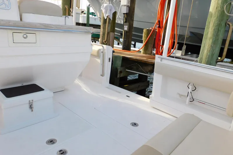 Happily Ever After Yacht Photos Pics Interior view of a 2016 Belzona 327 WA boat, featuring seating and storage compartments.
