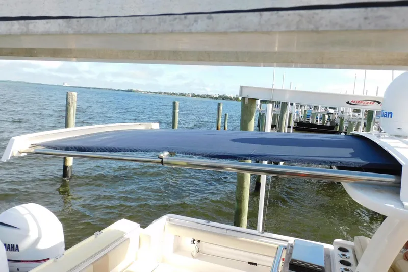 Happily Ever After Yacht Photos Pics 2016 Belzona 327 WA boat with blue canopy, docked by the water.