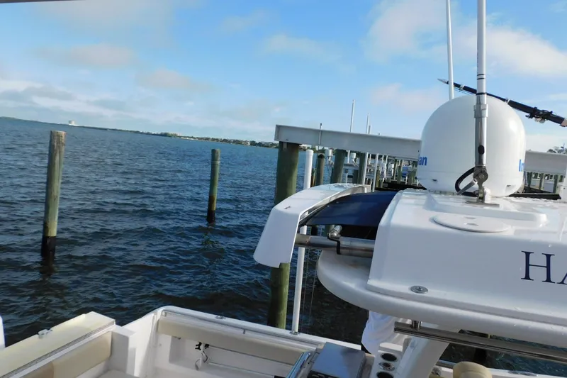 Happily Ever After Yacht Photos Pics Belzona 327 WA boat docked by the water, showcasing radar equipment, 2016 model.