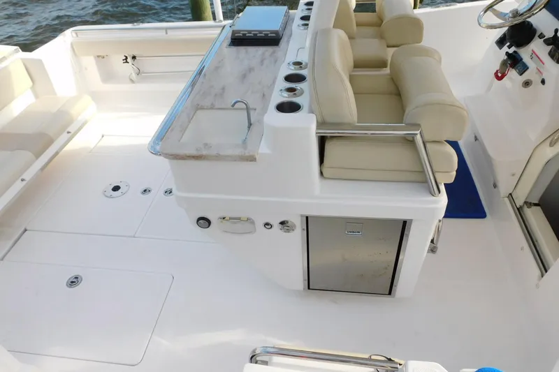 Happily Ever After Yacht Photos Pics Luxurious 2016 Belzona 327 WA boat interior with seating, sink, and storage.