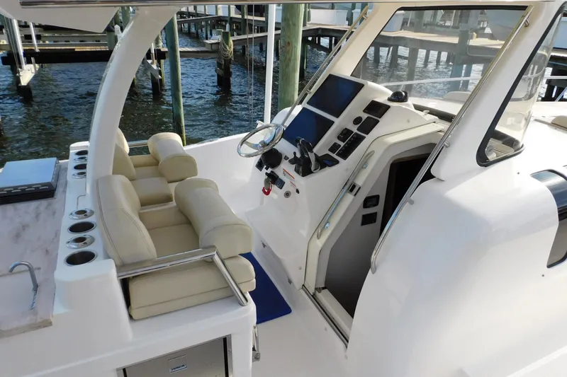 Happily Ever After Yacht Photos Pics 2016 Belzona 327 WA boat cockpit with helm, seating, and control panel.