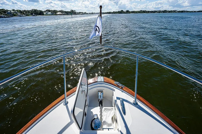  Yacht Photos Pics Bow view of 2023 Hinckley 40x yacht on open water under a sunny sky.
