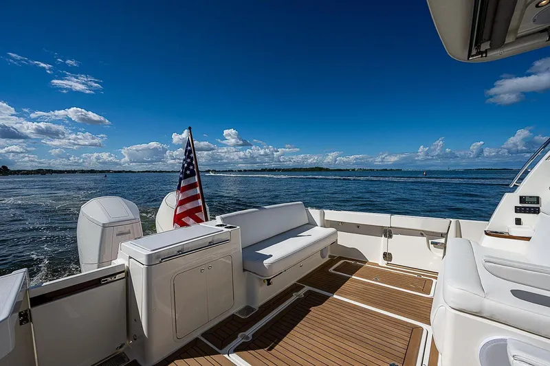  Yacht Photos Pics Hinckley 40x 2023 yacht deck with American flag, ocean view, and clear blue sky.