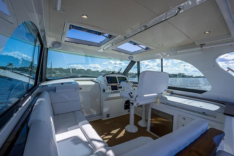  Yacht Photos Pics Luxurious interior of 2023 Hinckley 40x yacht with panoramic windows and plush seating.
