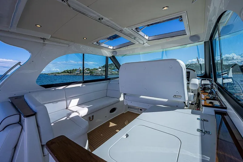  Yacht Photos Pics Luxurious interior of 2023 Hinckley 40x yacht with panoramic windows and plush seating.