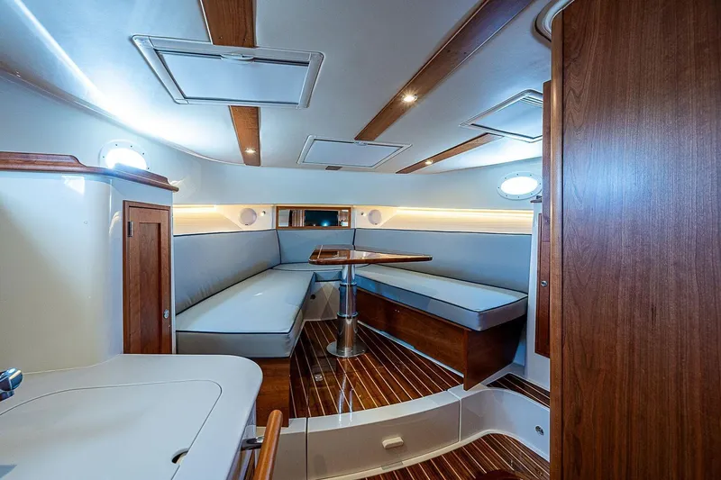  Yacht Photos Pics Luxurious interior of 2023 Hinckley 40x yacht with elegant wood finishes and seating area.