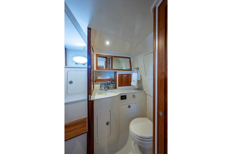  Yacht Photos Pics 2023 Hinckley 40x yacht bathroom with wooden accents and modern fixtures.